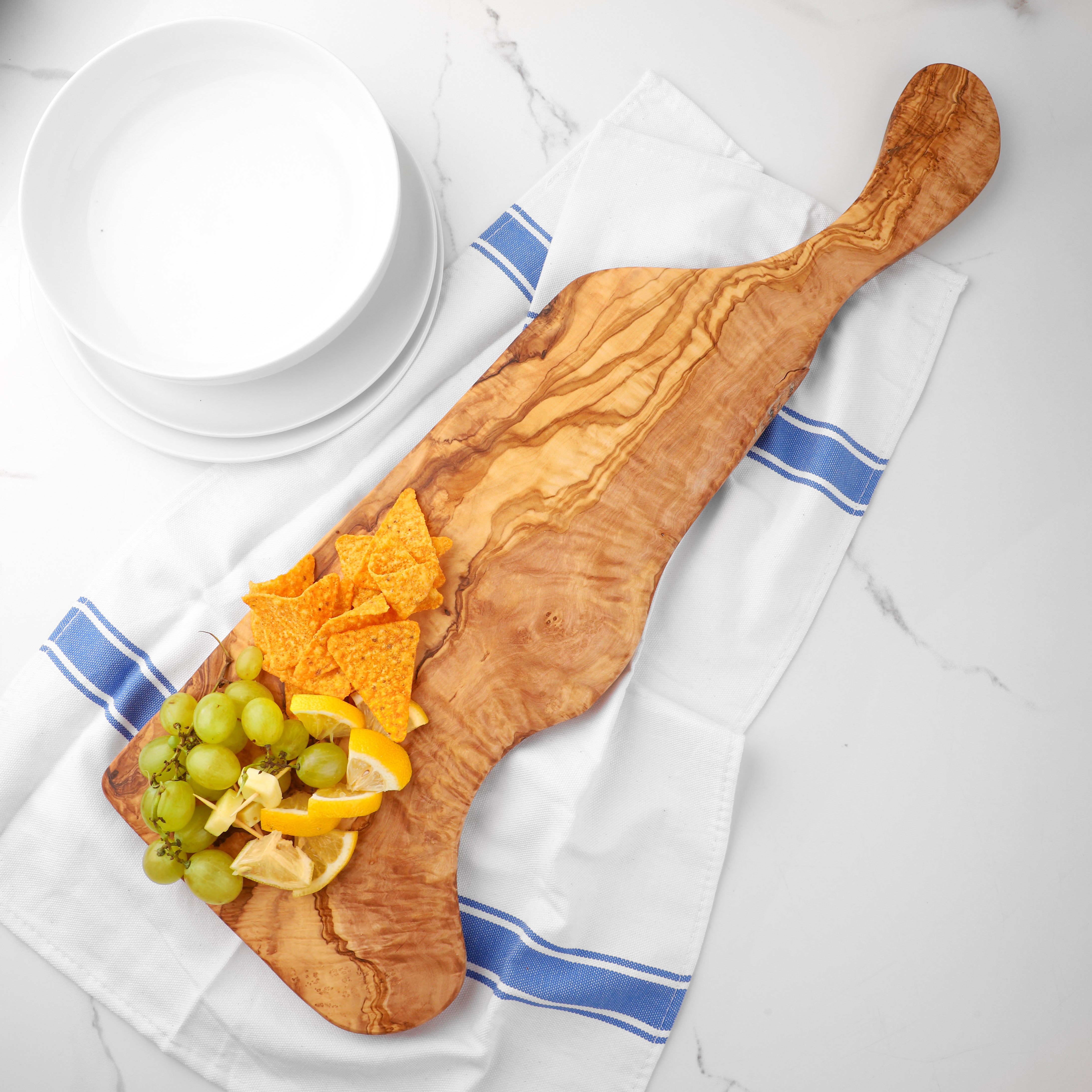 Olive Wood Charcuterie Board: Elevate your dining with this versatile board, perfect as a custom cheese board for gatherings or a daily-use cutting board. Its natural olive wood design brings unique grain patterns to your table.